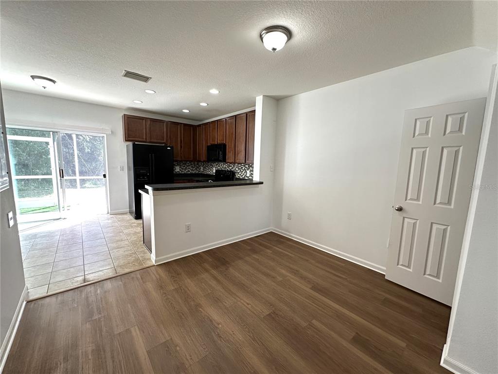 15816 Fishhawk View Drive Lithia, FL 33547 - Photo 6 of 30 a view of a kitchen with wooden floor and electronic appliances