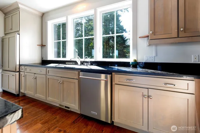 a view of an empty room with a fireplace and a window