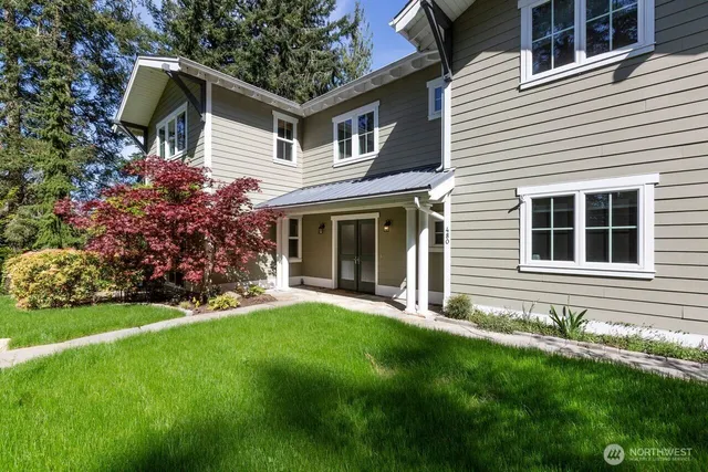 a front view of a house with a garden
