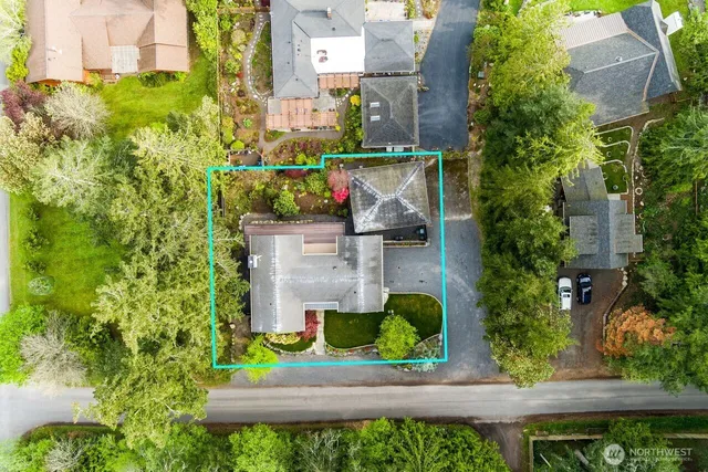 an aerial view of a house with a yard and garden
