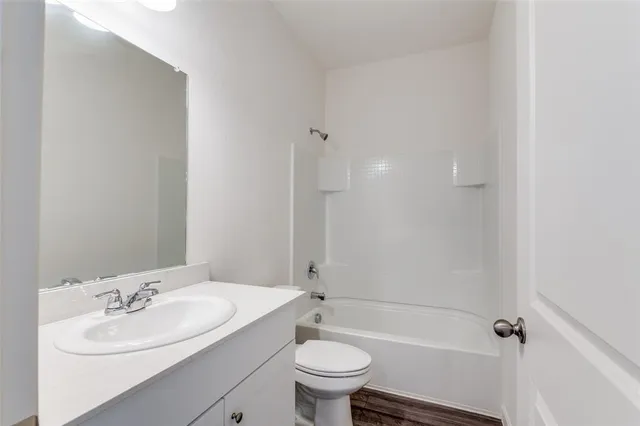 a bathroom with a sink toilet tub and shower