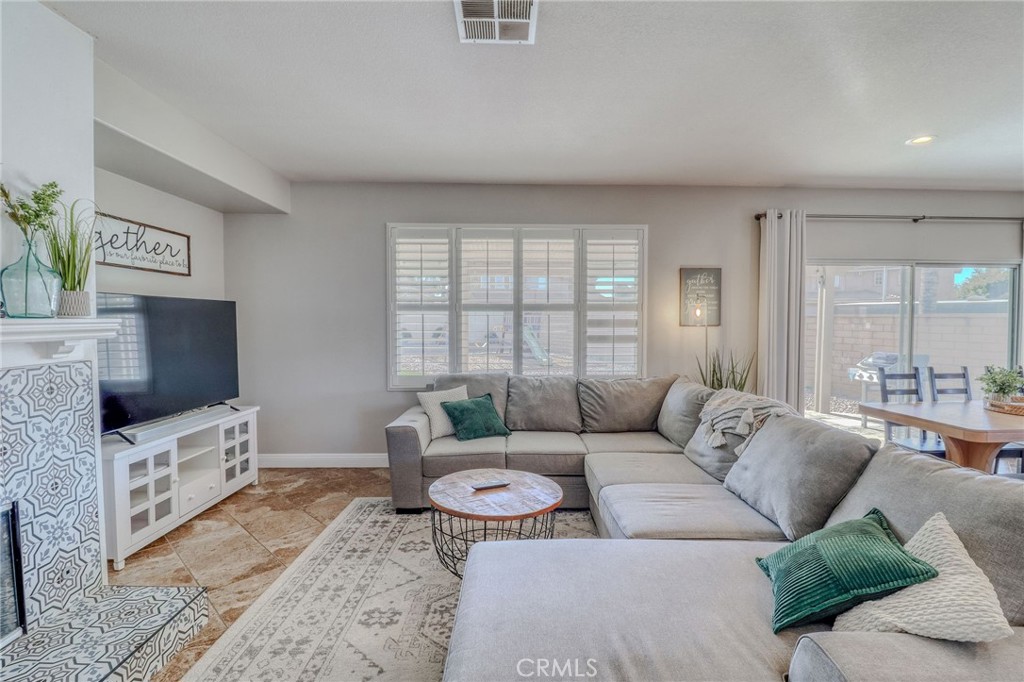 729 Windbound Avenue Beaumont, CA 92223 - Photo 12 of 73 a living room with furniture and a flat screen tv