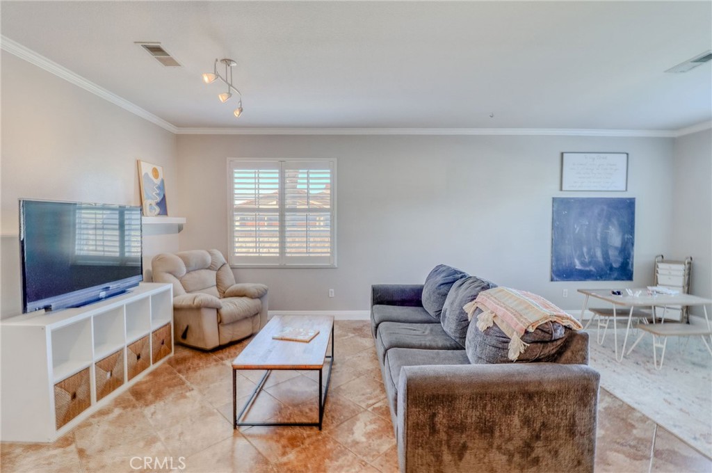729 Windbound Avenue Beaumont, CA 92223 - Photo 13 of 73 a living room with furniture and a flat screen tv