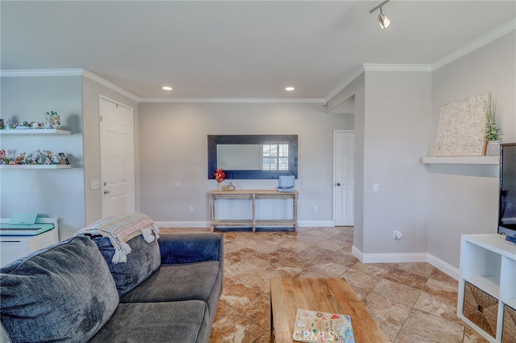 729 Windbound Avenue Beaumont, CA 92223 - Photo 16 of 73 a living room with furniture and a flat screen tv