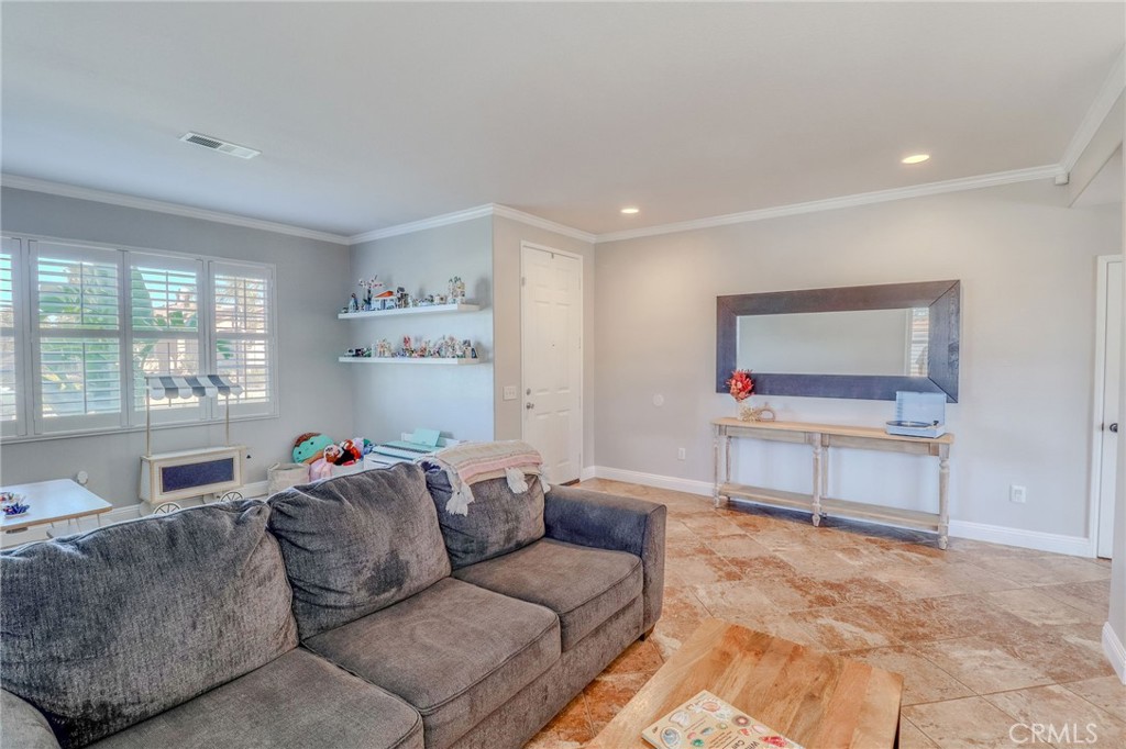 729 Windbound Avenue Beaumont, CA 92223 - Photo 17 of 73 a living room with furniture and a flat screen tv