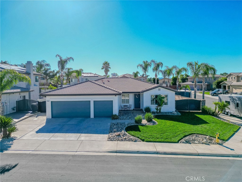 729 Windbound Avenue Beaumont, CA 92223 - Photo 2 of 73 a front view of a house with a garden and mountain view