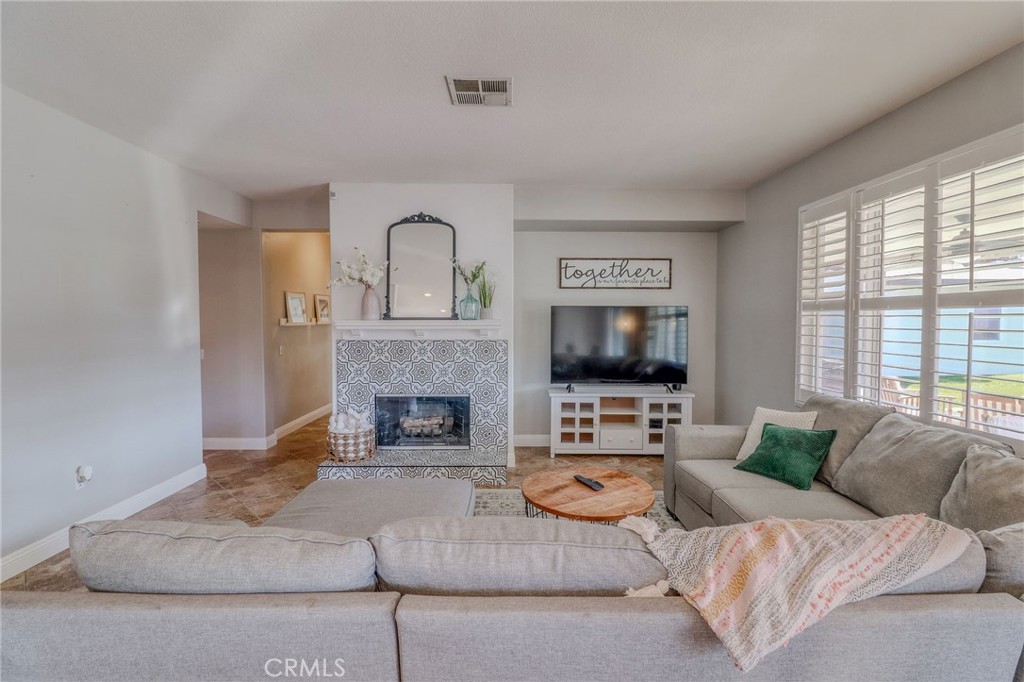 729 Windbound Avenue Beaumont, CA 92223 - Photo 29 of 73 a living room with furniture large window and a flat screen tv