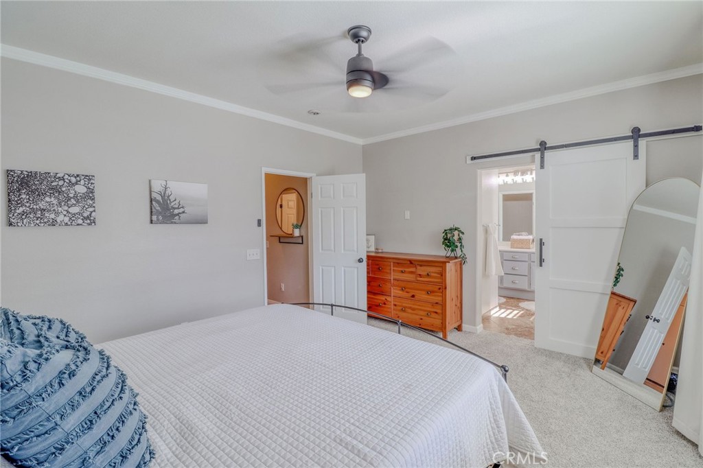 729 Windbound Avenue Beaumont, CA 92223 - Photo 37 of 73 a bedroom with a bed and a flat screen tv