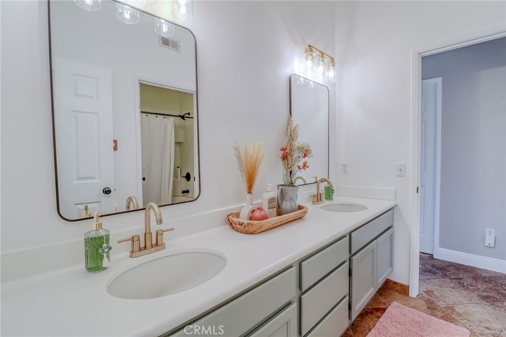 729 Windbound Avenue Beaumont, CA 92223 - Photo 44 of 73 a bathroom with a granite countertop sink and a mirror
