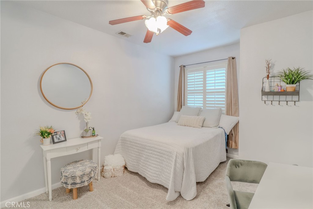 729 Windbound Avenue Beaumont, CA 92223 - Photo 47 of 73 a bedroom with a bed chair and a chandelier