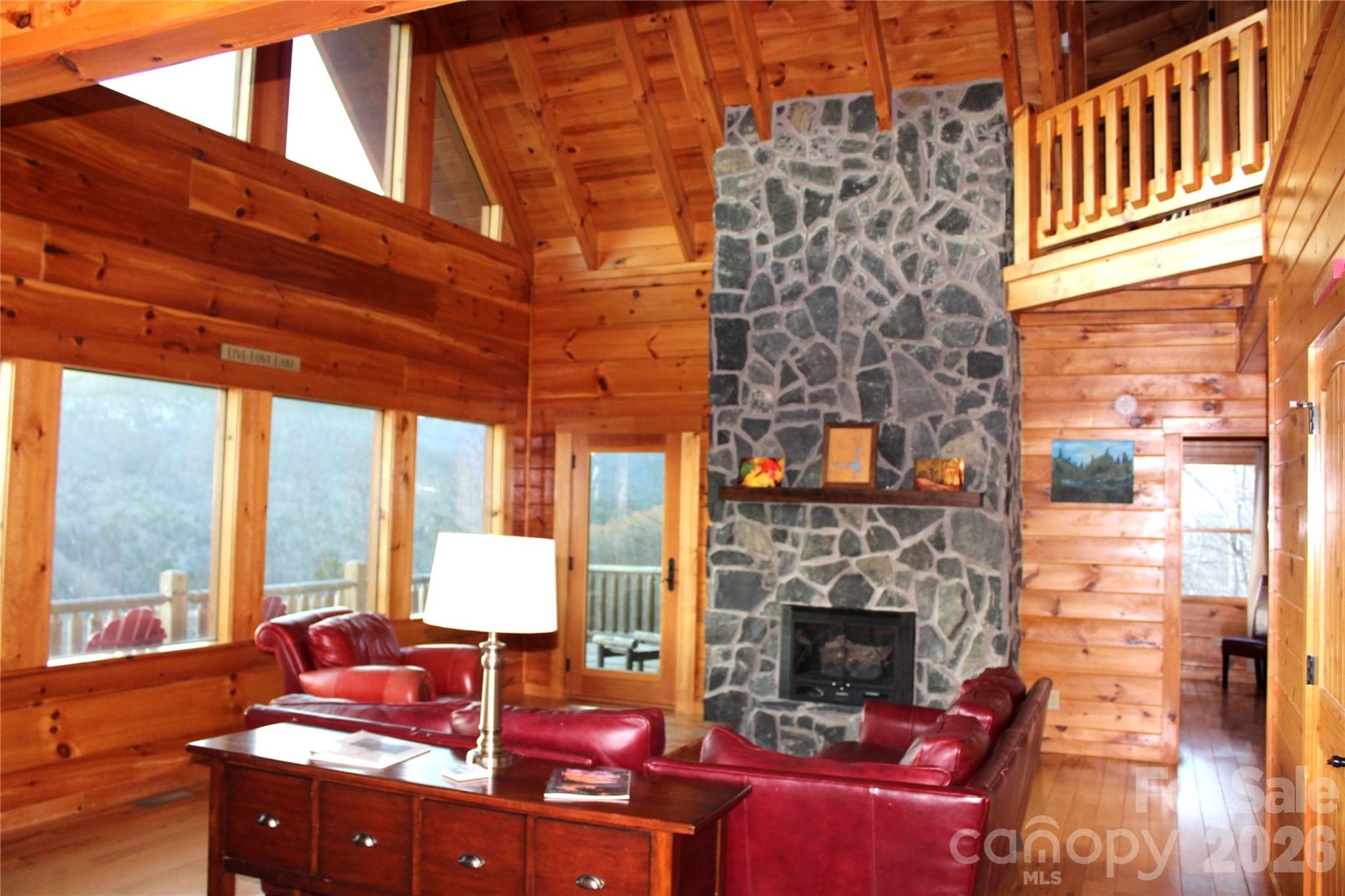 169 Overlook Point Lane Lake Lure, NC 28746 - Photo 11 of 39 a living room with furniture and a fireplace