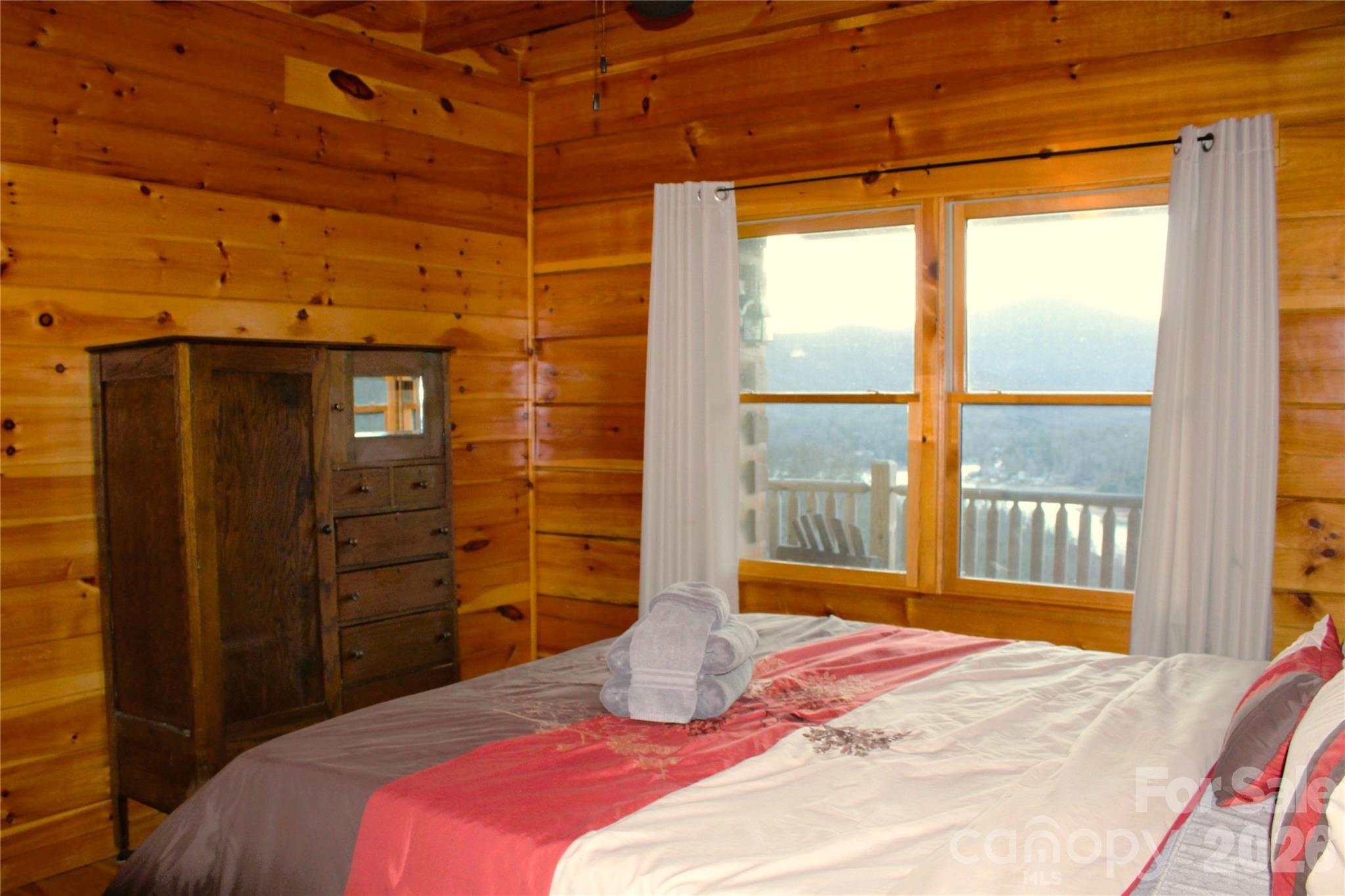 169 Overlook Point Lane Lake Lure, NC 28746 - Photo 18 of 39 a bedroom with a bed and a large window