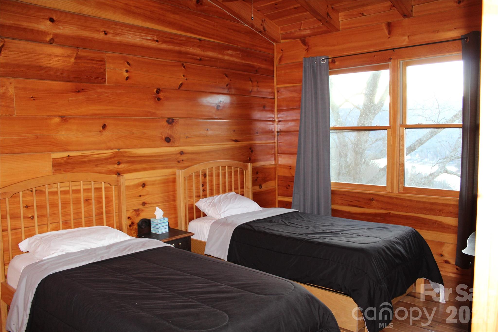 169 Overlook Point Lane Lake Lure, NC 28746 - Photo 27 of 39 a bedroom with a bed a closet and next to a window
