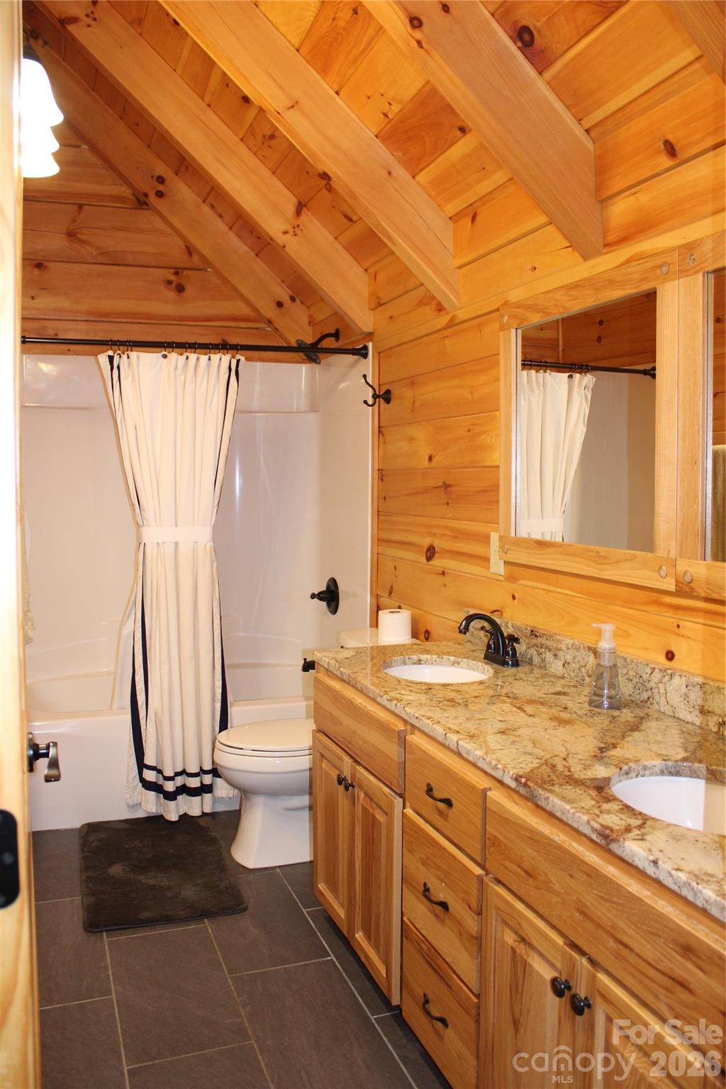 169 Overlook Point Lane Lake Lure, NC 28746 - Photo 29 of 39 a bathroom with a granite countertop sink a mirror and a shower