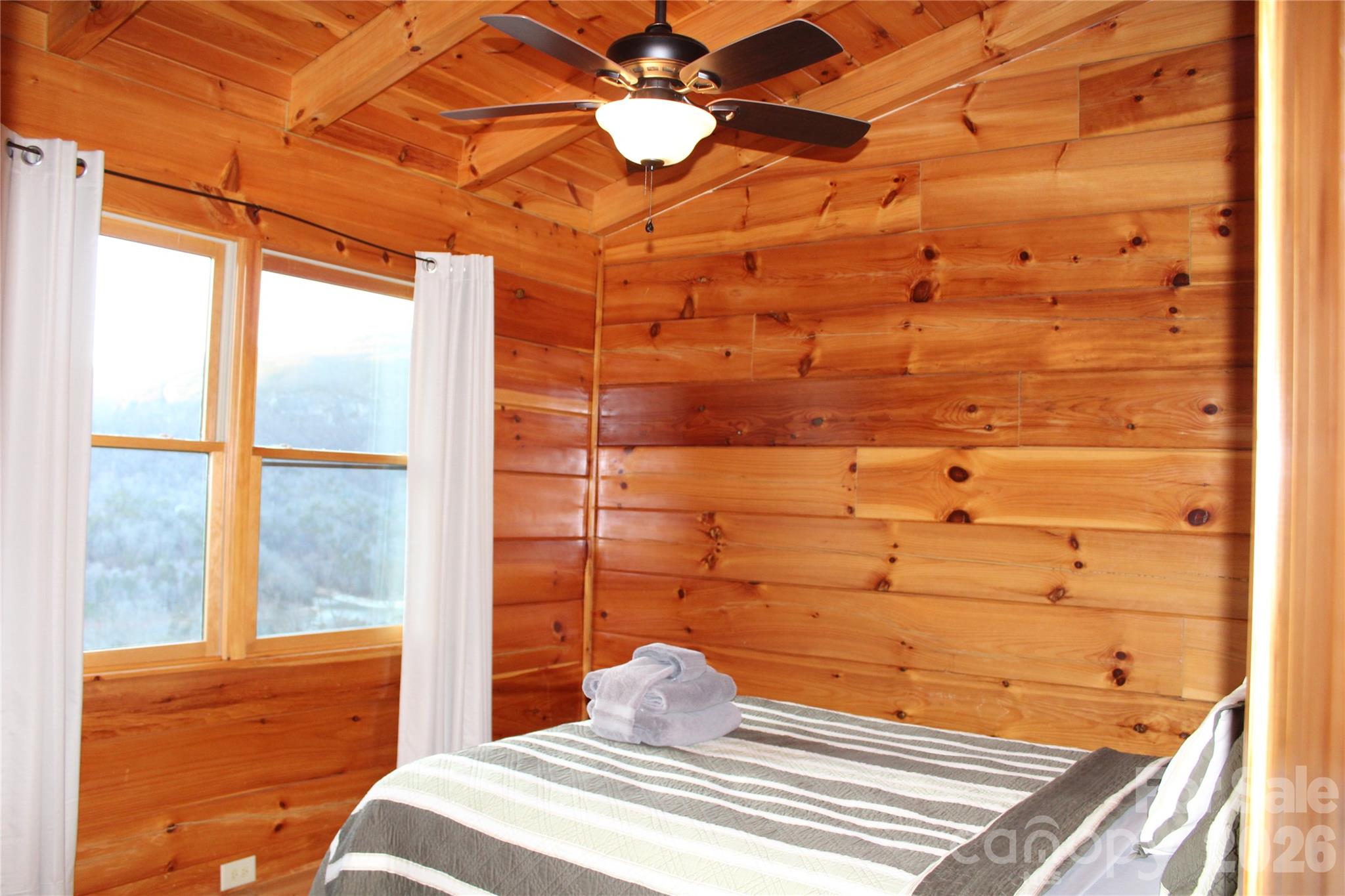 169 Overlook Point Lane Lake Lure, NC 28746 - Photo 30 of 39 a bedroom with a bed and a window