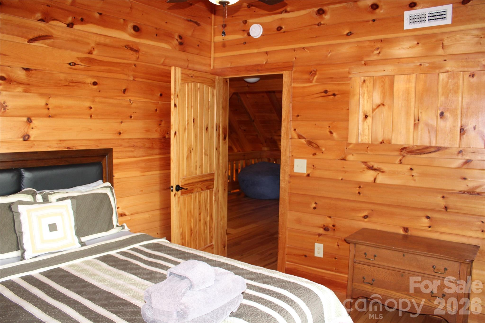 169 Overlook Point Lane Lake Lure, NC 28746 - Photo 31 of 39 a bedroom with a bed and wooden floor