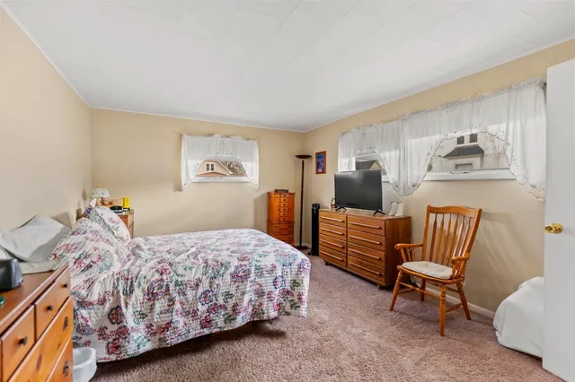 a bedroom with a bed and a chair