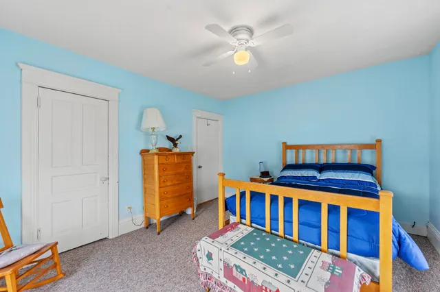 a bedroom with furniture and a baby crib