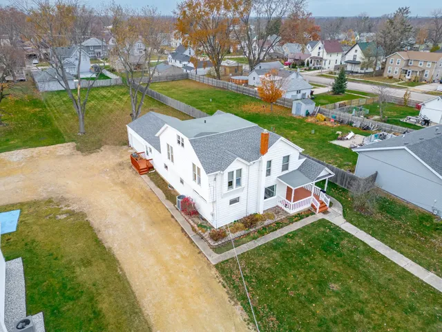 an aerial view of a house with a garden and trees