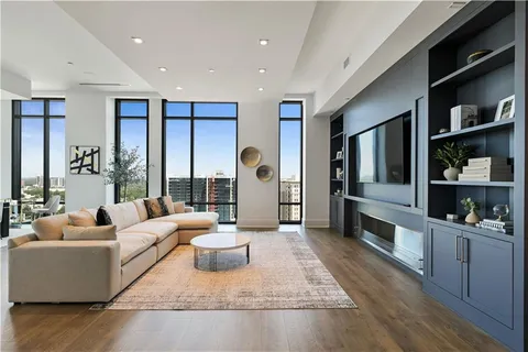 a living room with furniture and a book shelf