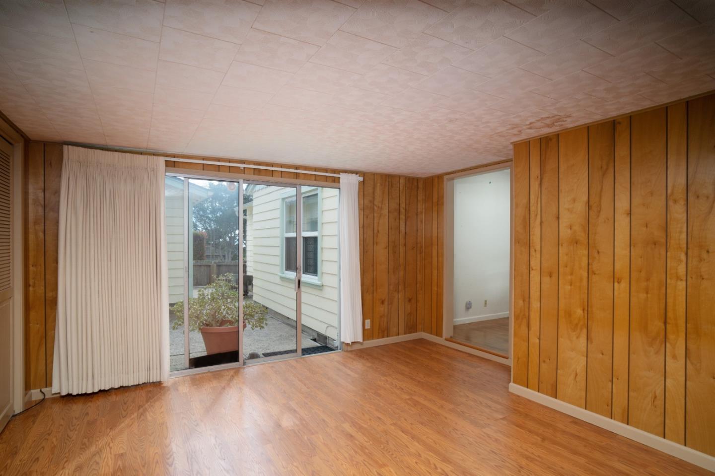 305 Stuart Avenue Pacific Grove, CA 93950 - Photo 11 of 24 a view of empty room with wooden floor and fan