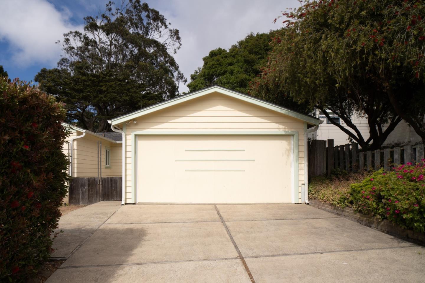 305 Stuart Avenue Pacific Grove, CA 93950 - Photo 16 of 24 a front view of a house with a yard and garage
