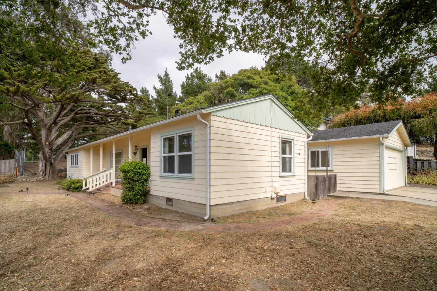 305 Stuart Avenue Pacific Grove, CA 93950 - Photo 18 of 24 a view of a house with a yard and large tree