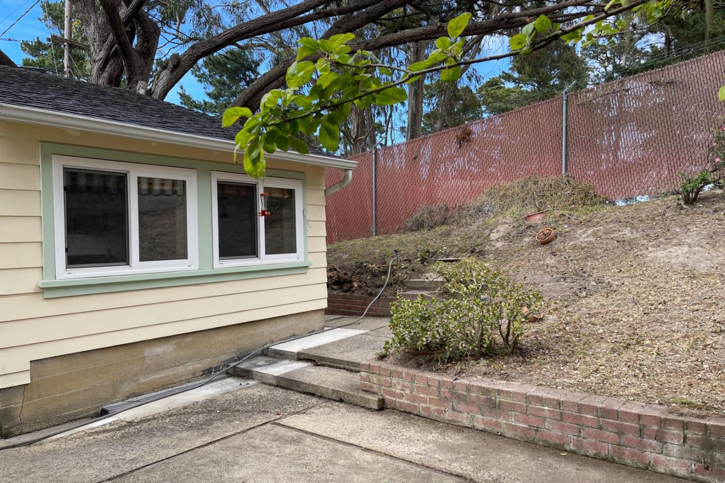 305 Stuart Avenue Pacific Grove, CA 93950 - Photo 21 of 24 a house with a tree in front of it