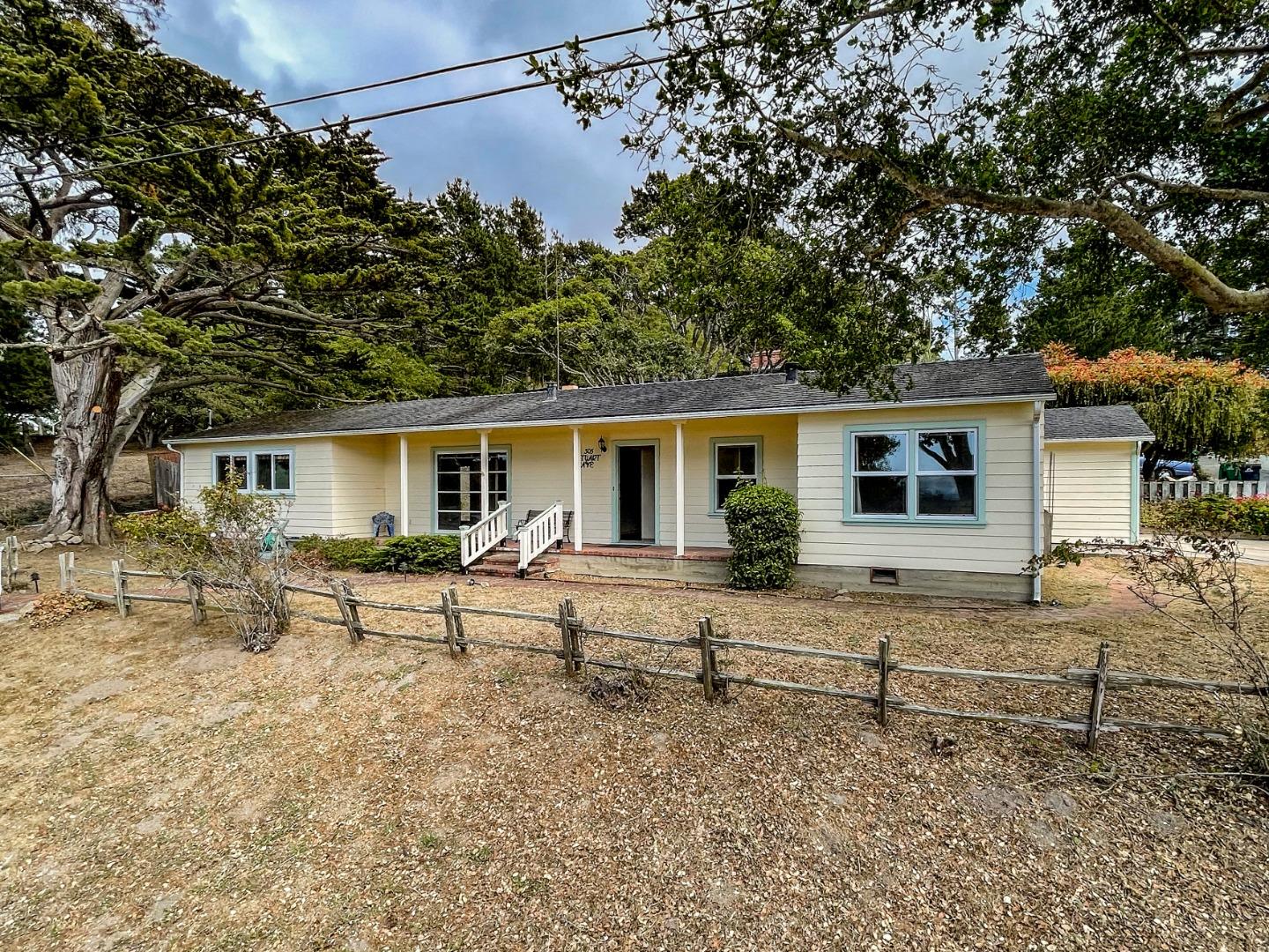 305 Stuart Avenue Pacific Grove, CA 93950 - Photo 23 of 24 front view of house with a bench and a tree