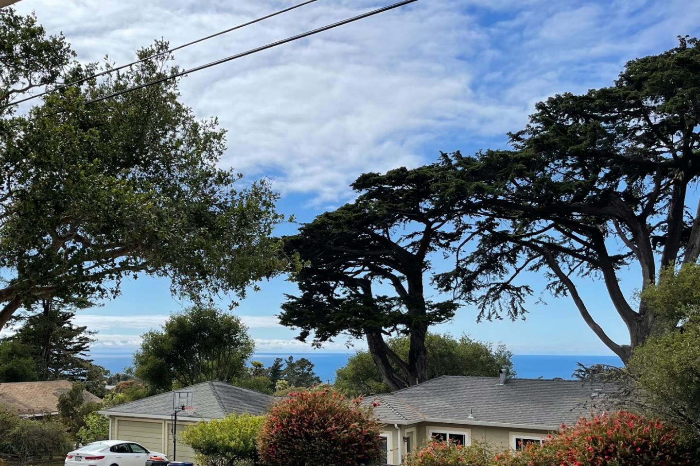 305 Stuart Avenue Pacific Grove, CA 93950 - Photo 24 of 24 a view of a house with a tree in the background