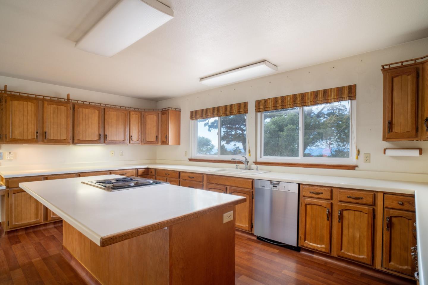 305 Stuart Avenue Pacific Grove, CA 93950 - Photo 8 of 24 a kitchen with wooden cabinets and sink