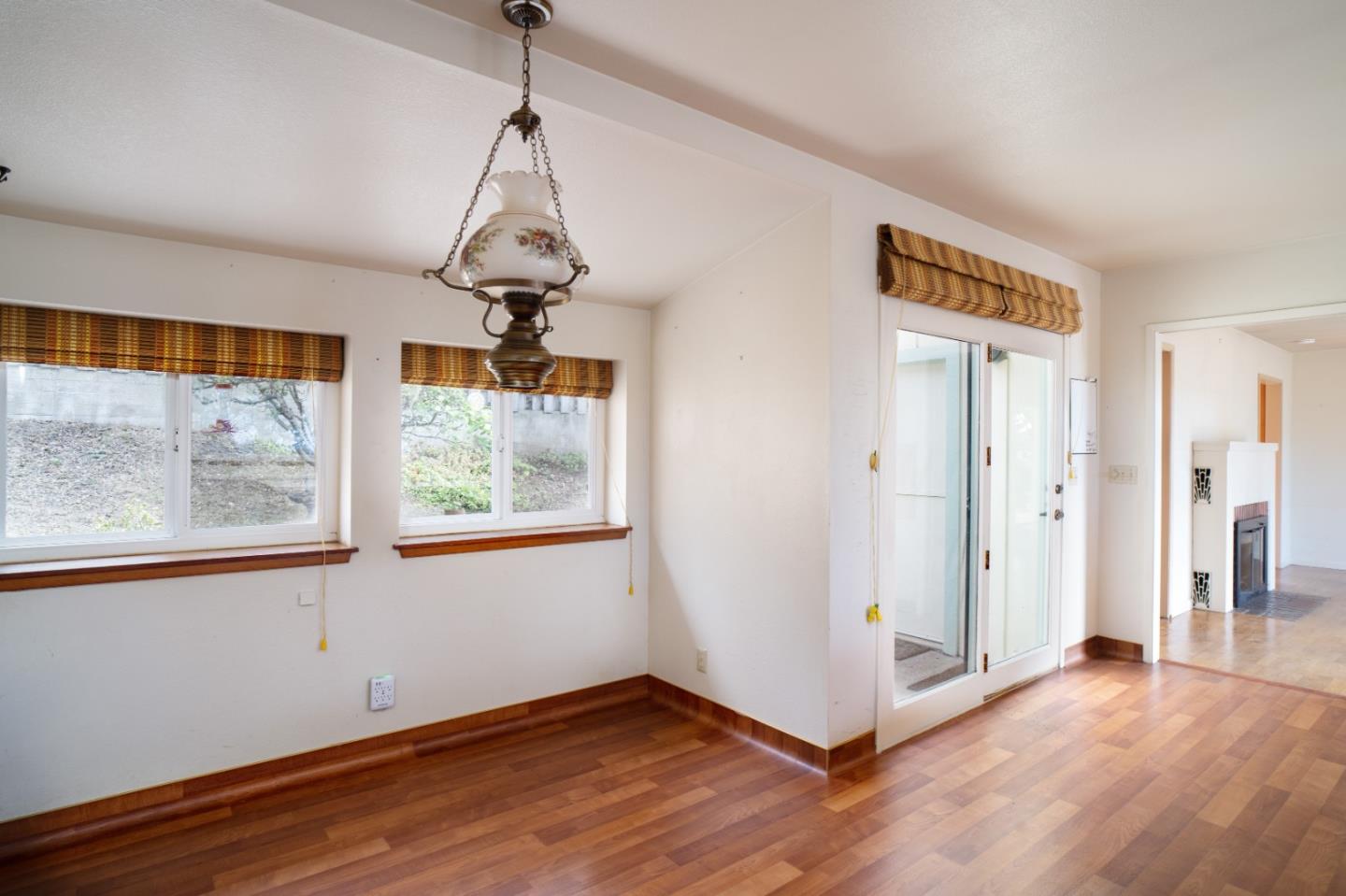 305 Stuart Avenue Pacific Grove, CA 93950 - Photo 9 of 24 a view of an empty room with wooden floor and a window