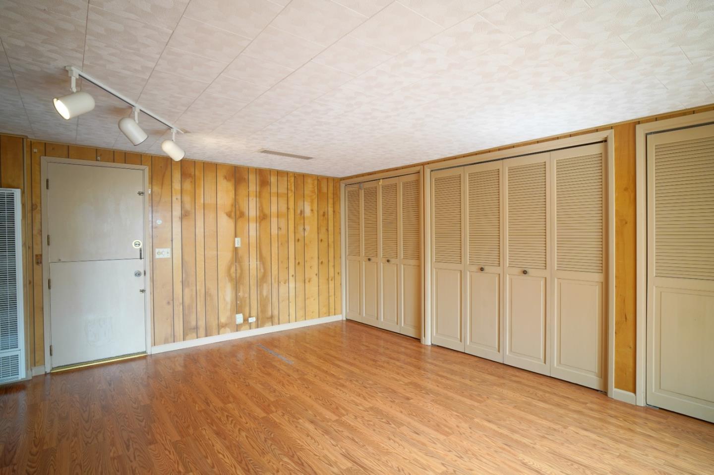 305 Stuart Avenue Pacific Grove, CA 93950 - Photo 10 of 24 a view of an empty room with wooden floor