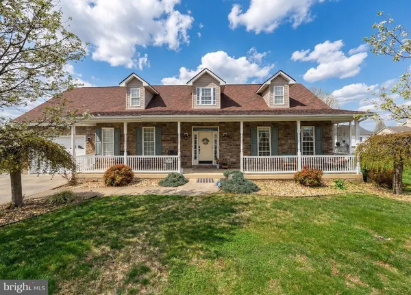 a front view of a house with garden and porch