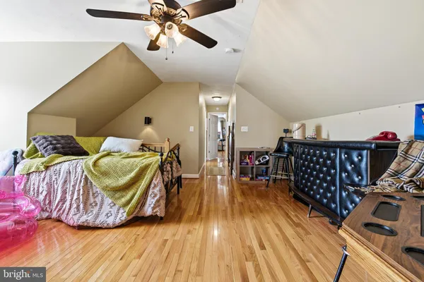 a spacious bedroom with a bed and a chandelier