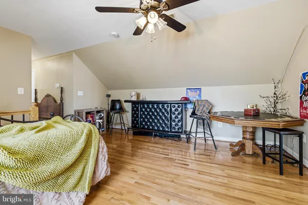 a bedroom with furniture and a large window
