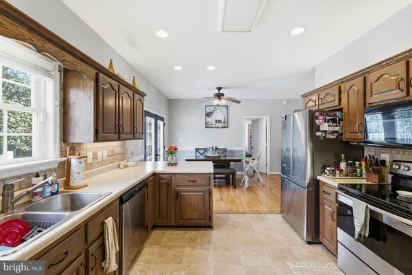 a kitchen with lots of counter top space and stainless steel appliances