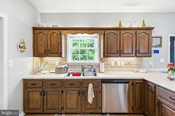 a kitchen with a sink cabinets and window