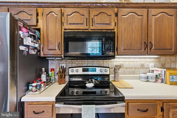 a stove top oven sitting inside of a kitchen