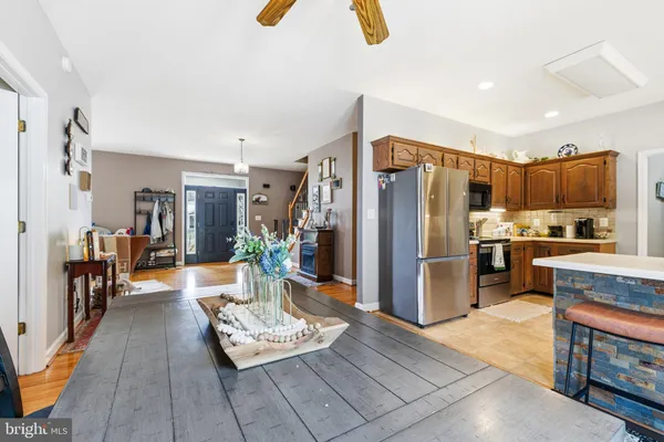 a living room with furniture and a kitchen view
