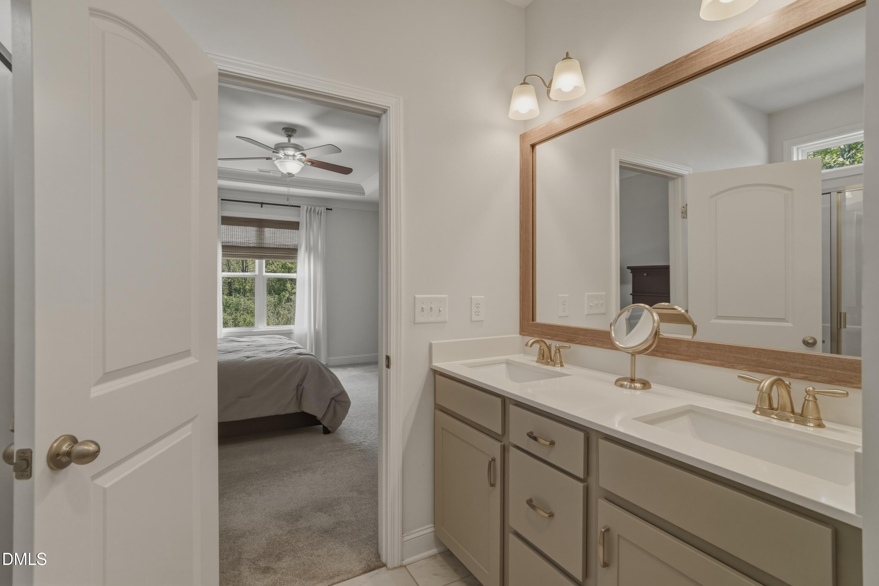 386 Howards Crossing Drive Wendell, NC 27591 - Photo 12 of 31 a en suite bathroom with a granite countertop sink and a mirror