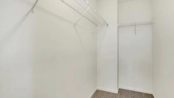 an empty room with a bathroom and a sink