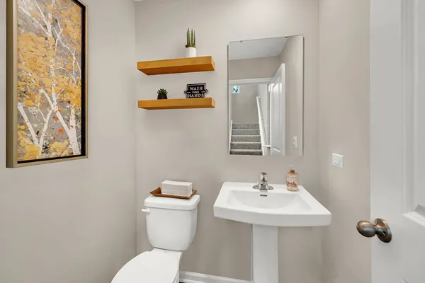a white toilet sitting next to a bathroom sink