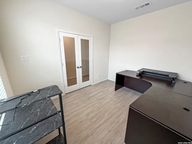 a view of bedroom with wooden floor