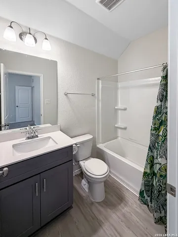 a bathroom with a sink toilet a mirror and shower