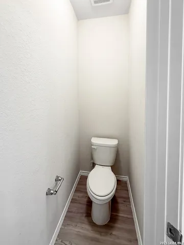 a white toilet sitting next to a white cabinet