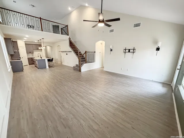 a view of a hallway with wooden floor and staircase