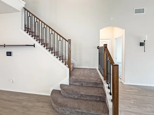 a view of entryway and hall with wooden floor