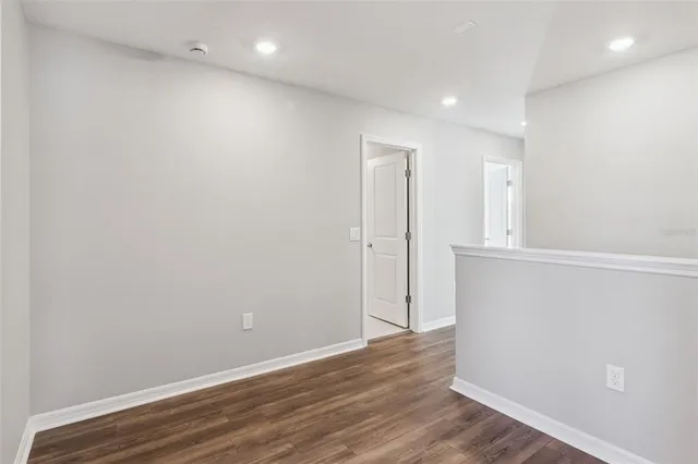 an empty room with wooden floor