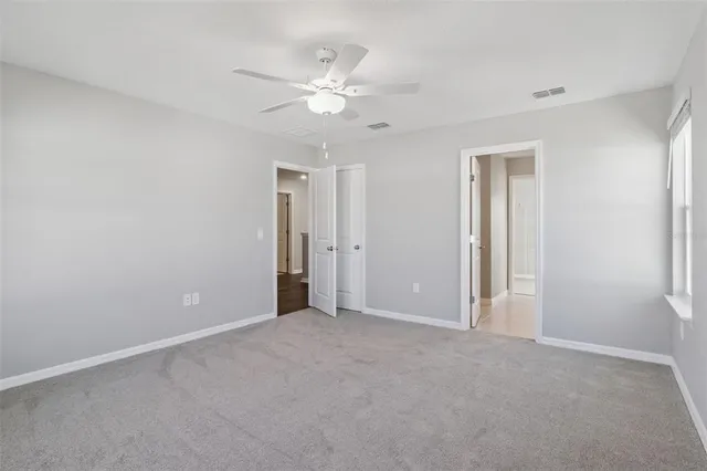 a view of an empty room with a fan
